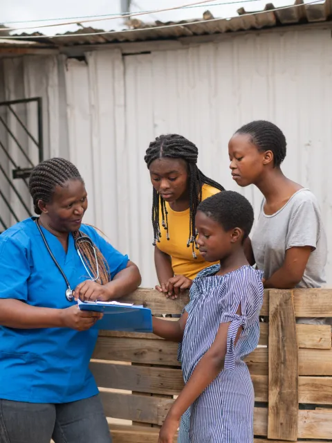 Healthcare professional with three young women