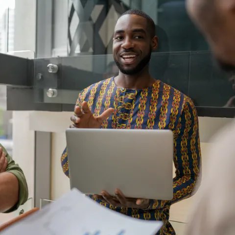 Two men discussing with laptop