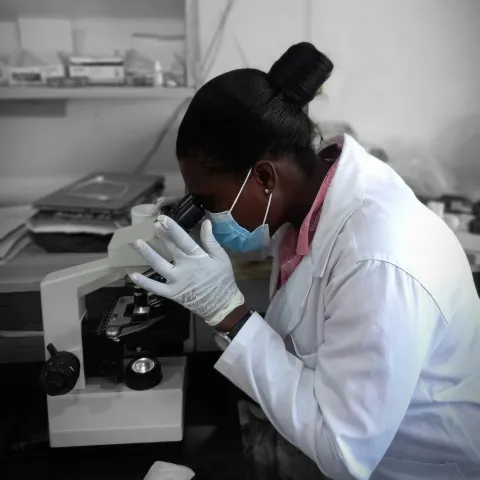 Women looking into microscope